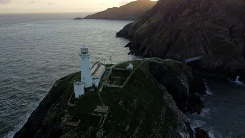 South Stack lighthouse aerial descending view of rugged island mountains Stock Footage 281095644