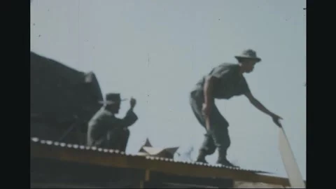 SOUTH VIETNAM - 1969: Base construction - Roofers on a corrugated roof Stock Footage 343938643