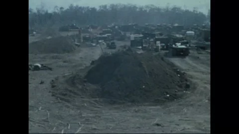 SOUTH VIETNAM - 1969: Engineer base - Tarpaulin-covered equipment park Stock Footage 343932742