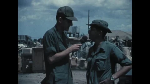 SOUTHEAST ASIA - 1969: Supply interview - Cable hangs between two reservists Stock Footage 344005370