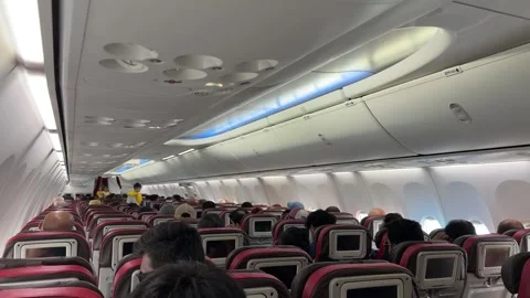 Southeast Asia flight plane interior of travellers inside cabin mid-flight Stock Footage 340544538
