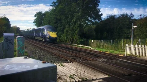 Southeastern high speed Javelin train passing rural railway crossing, Kent, UK. Stock Footage 167138322