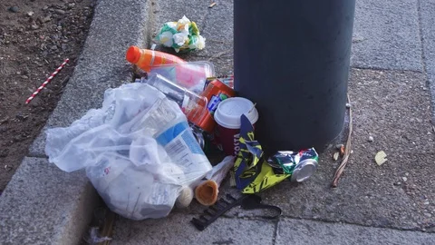 Southend, UK - Circa 2019: Full litter bin overflowing with rubbish on a street Stock Footage 129345034