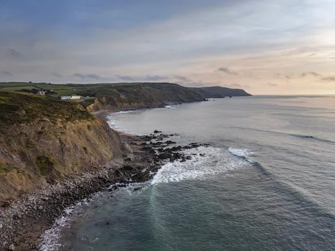 Southern cliffs of Widemouth Bay beach at low tide before sundown 스톡 사진