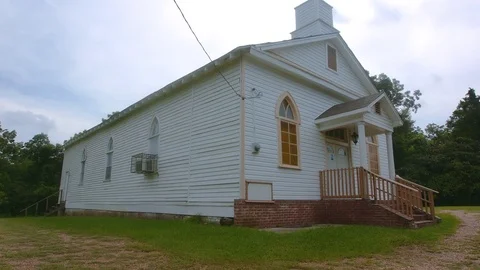 Southern country church in Mississippi wide shot from side oblique pan Stock Footage