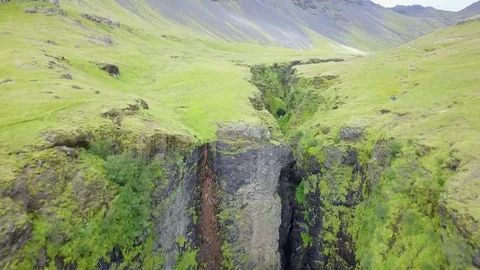 Southern Icelandic drone shot of large ravine with river running Stock Footage