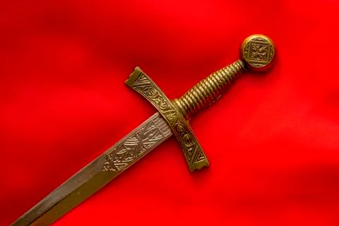 Souvenir dagger on a red background 스톡 사진