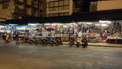 Souvenir shop storefront view on roadside at night. Tourists shopping, Thailand Stock Footage 234594992