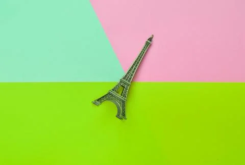 Souvenir statuette of the Eiffel Tower on a multicolored pastel background. T 库存照片