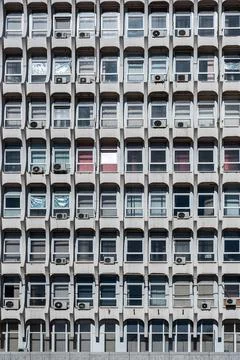 Soviet architecture. Facade of gray building with windows Stock Photos