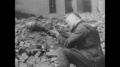 Soviet artillery fires, a Soviet captures a German soldier from his hiding spot Stock Footage 103382647