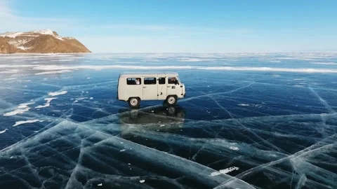 Soviet Car Uaz Rides On The Icy Surface Of Frozen Baikal lake. Side view. Stock Footage 140962373
