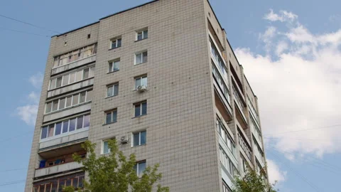 Soviet era panel apartment building under a blue sky. Brutalist post-Soviet.. Video stock 339529599