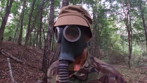 Soviet gas mask GP-4 "Green Elephant", man in the forest, vintage USSR. Stock Footage 316977995