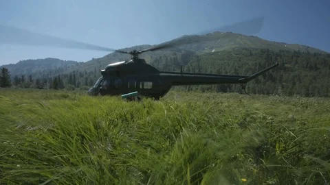 Soviet helicopter operates at helipad in a clearing in nature Stock Footage 94691830