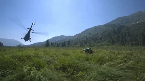 Soviet helicopter operates at helipad in a clearing in nature Stock Footage 94691851