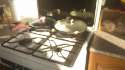 Soviet kitchen with a white gas stove and two frying pans in sunlight from the Stock Footage 307897309