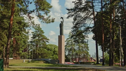 Soviet monument standing tall in a serene forest on a bright summer day. Stock Footage 343207013