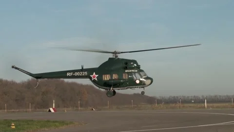 Soviet multipurpose helicopter Mi-2 (NATO: Hoplite) lands on runway. Video stock 139269594