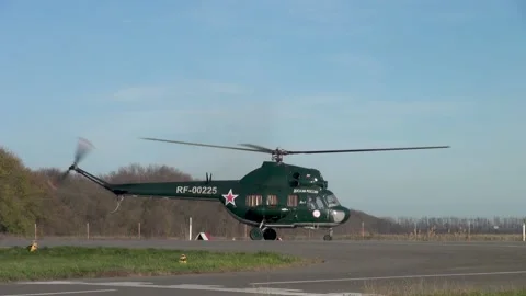 Soviet multipurpose helicopter Mi-2 (NATO: Hoplite) lands on runway. Stock Footage 139273381