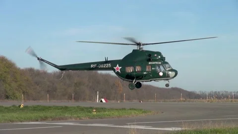 Soviet multipurpose helicopter Mi-2 (Hoplite) performs various aerobatics. Stock Footage 139399356