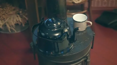 An Soviet obsolete iron mug and metal teapot is heated for brewing tea Stock Footage 323933962
