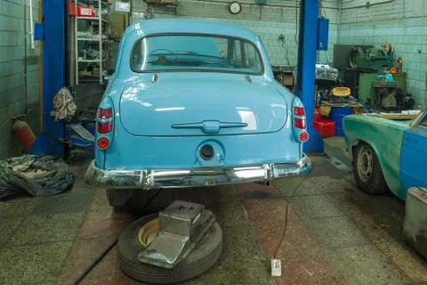 Soviet oldtimer "Moskvich-403" in a car service. Back view Stock Photos