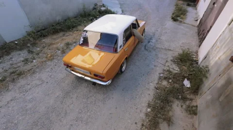 Soviet retro ZHIGULI lada first model moving through the old street Stock Footage 61320455