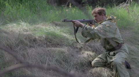 Soviet soldier fires back and drops the wounded. World war II. Stock Footage 63752991