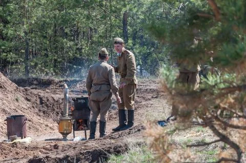 Soviet soldiers are preparing dinner. Reconstruction hostilities 2018-04-30 Stock Photos