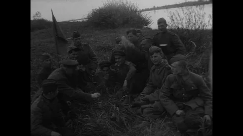 Soviet troops rest, fire weapons on bank of river Stock Footage 103378721