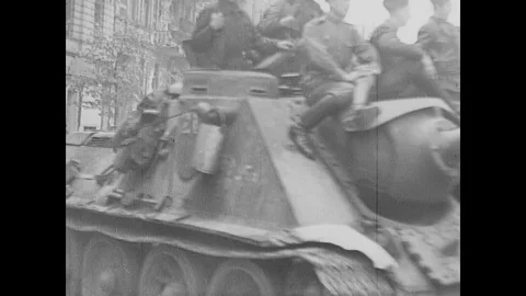 Soviet troops on tanks advance into Berlin and cheer senior officer Stock Footage 103382959