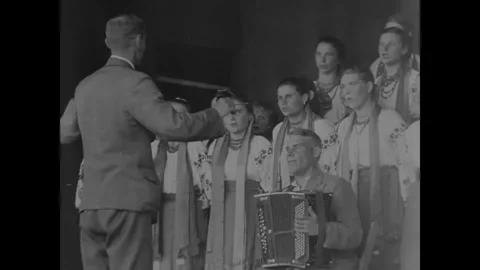 SOVIET UNION - 1944: Base Concert Night - Conductor Cues The Choir Onstage Stock Footage 343997419