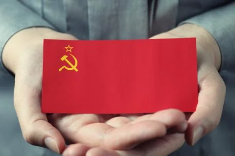 Soviet Union flag in palms Stock Photos