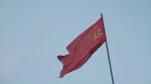 Soviet USSR Russian Flag Blowing in Slow Motion Against Blue Sky in Russia Stock Footage 112975416