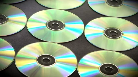 Sow motion arranged in rows of CD or DVDs disks Stock Footage 76730249