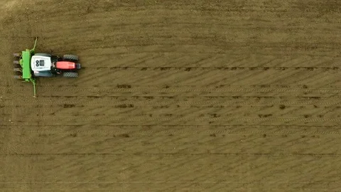 Sowing crops on the field. Spring agricultural work. Aerial View. Stock Footage 77166237