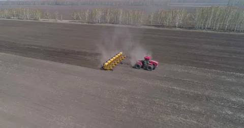 Sowing. A farmer on a big tractor sows a crop. Stock Footage 160544918