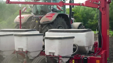 Sowing the field with corn grains. tractor works the field with a seeder. Stock Footage 207786547