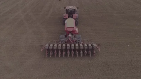Sowing machine pulled by a tractor goes to the ground Stock Footage 159805514