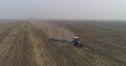 Sowing preparation. A farmer on a small tractor cultivates the soil in the field Stock Footage 160547147