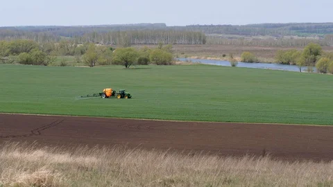 Sowing, processing of fields. Pest control. Trailer sprayer in operation. Stock Footage 129888077