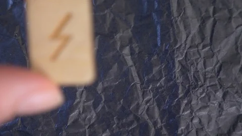 Sowulo rune. close-up, hand puts the rune on the surface for divination. 4k Stock Footage 87879995