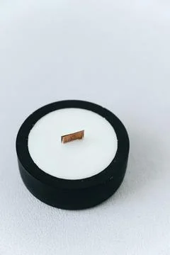 Soy Candle in Black Flat Plaster Candlestick. Wooden Wick. Concept of Warmth  Stock Photos