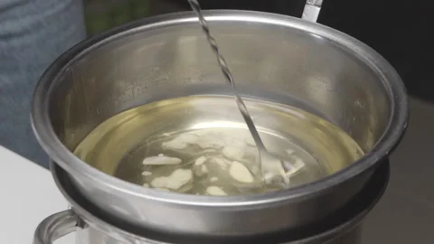 Soy wax is melted to make handmade candles Stock Footage 182372004