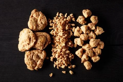 Soya chunks on black background, from above Stock Photos