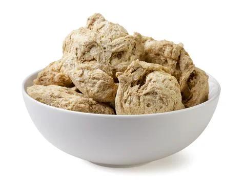 Soya chunks in a plate close-up on a white background. Isolated Stock Photos