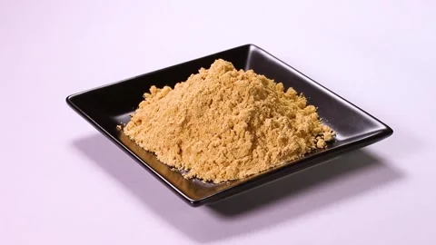 Soybean flour on a plate rotating Stock Footage 323575077