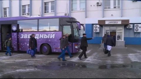 Soyuz MS-11 Astronauts Ononenko, McClain, Saint-Jacques departing transfer bus Stock Footage 273697617