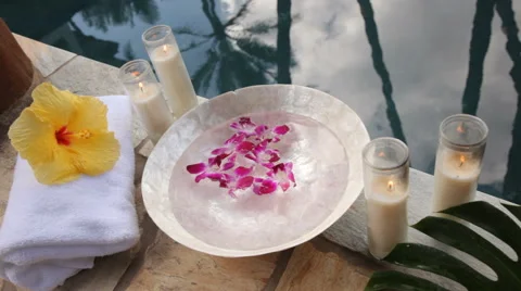 Spa accessories poolside with palm trees reflecting Stock Footage 62280896